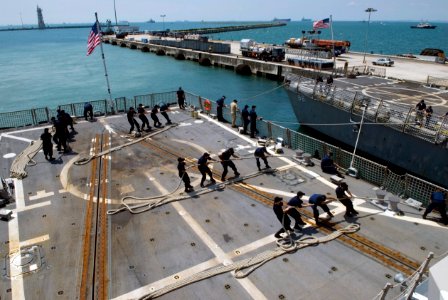 US Navy 090424-N-3541A-050 Sailors assigned to the Arleigh Burke-class guided-missile destroyer USS Kidd (DDG 100) heave mooring lines attached to the Arleigh Burke-class guided-missile destroyer USS Preble (DDG 88)