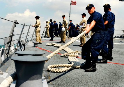 US Navy 090424-N-9928E-088 Sailors heave a mooring line on the forecastle aboard the Arleigh Burke-class guided-missile destroyer USS Kidd (DDG 100) as the ship moors pier side