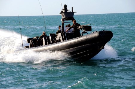 US Navy 090428-N-4205W-905 A Special Warfare Combatant-Craft Crewman (SWCC) assigned to Special Boat Team (SBT) 20 navigates a rigid-hull inflatable boat photo