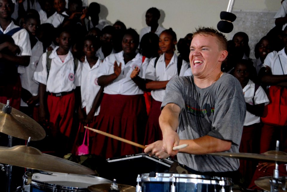 US Navy 090428-N-1688B-109 Musician 3rd Class Jason McDonough performs while surrounded by students from Lycee Primary School in Port Gentil, Gabon