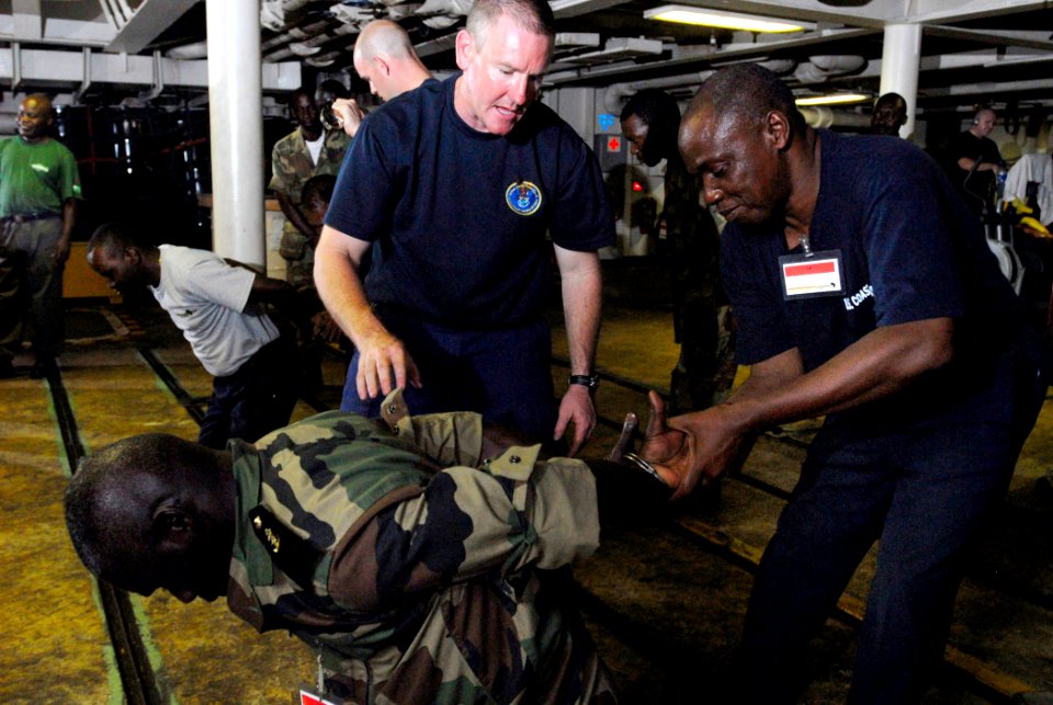 US Navy 090428-N-7948C-405 U.S. Coast Guard Lt. John McKinnon observes a Gabonese sailor practicing proper handcuffing techniques aboard the amphibious transport dock ship USS Nashville (LPD 13) during an Africa Partnership Sta