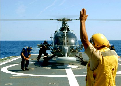 US Navy 090426-N-7092S-451 1-Er. Miestre Jesus Espinosa Santiago guides a Bolkow BO-105 helicopter to land on the flight deck of the Mexican Navy ocean patrol ship ARM Oaxaca (PO-161)