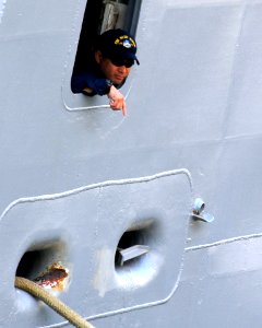 US Navy 090429-N-0807W-230 A sailor assigned to the amphibious command ship USS Blue Ridge (LCC 19) looks out from a mooring station during sea and anchor detail
