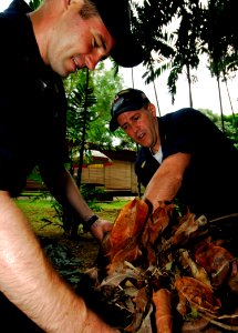 US Navy 090428-N-6538W-178 Chief Machinist's Mate James Trogden and Senior Chief Cryptological Technician Technical Alex Peloquin pick up leaves and debris