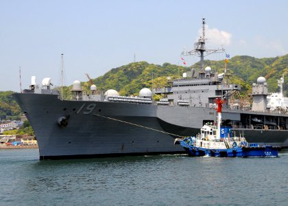 US Navy 090429-N-0807W-322 A tugboat guides the amphibious command ship USS Blue Ridge (LCC 19) as it departs Fleet Activities Sasebo after a scheduled port visit