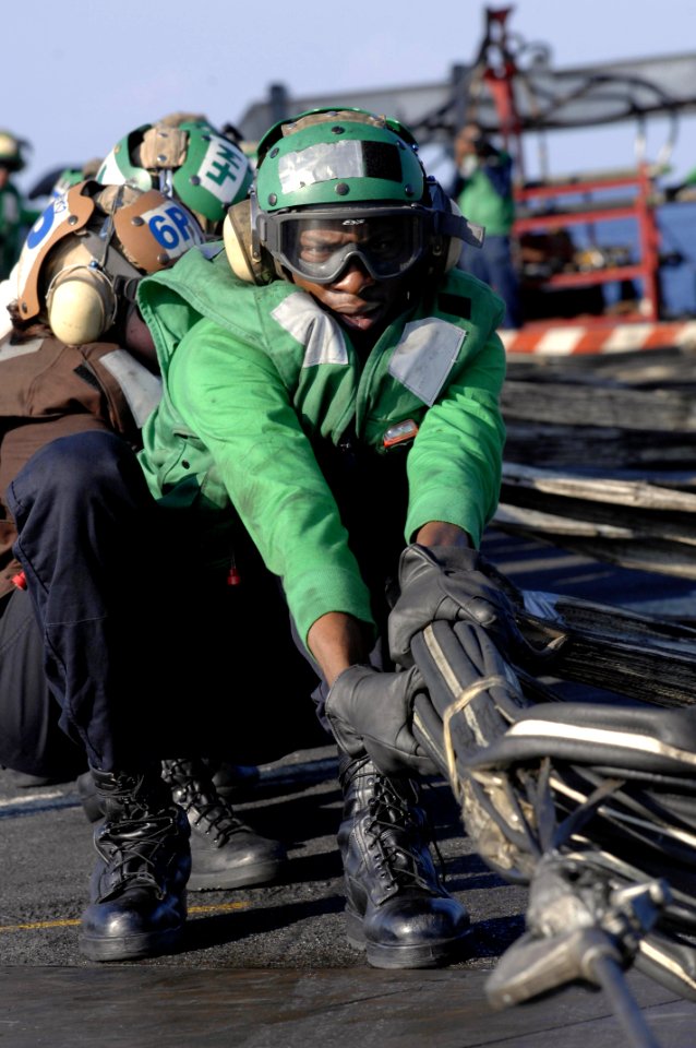 US Navy 090430-N-3702E-033 Aviation Boatswain's Mate (Equipment) Milton Holt from Air department, V-2 division, pulls on the webbing of the barricade