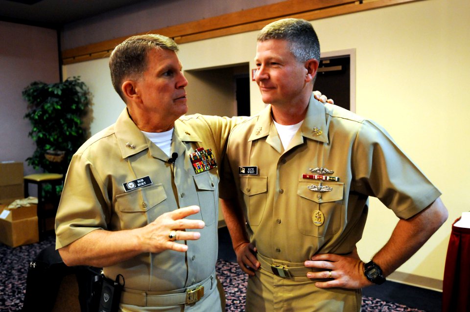 US Navy 090428-N-9818V-017 Master Chief Petty Officer of the Navy (MCPON) Rick West speaks with Chief of Navy Chaplains Rear Adm. Robert F. Burt before kicking off the Individual Agumentee Symposium at Naval Base Kitsap Bangor