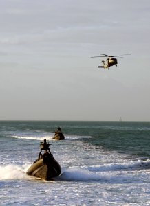 US Navy 090428-N-4205W-200 A Special Warfare Combatant-Craft Crewman (SWCC) assigned to Special Boat Team (SBT) 20 navigates a rigid-hull inflatable boat