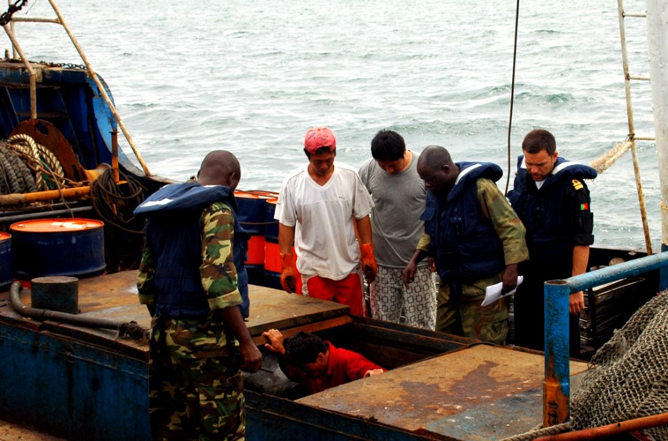 US Navy 090429-N-1655H-181 Portuguese Navy Lt. Cmdr. Antonio Mourinha and Gabonese sailors inspect a holding bay for fish aboard an illegal fishing vessel during an Africa Partnership Station Nashville fisheries engagement