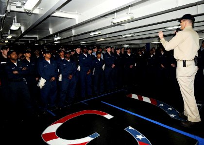 US Navy 090428-N-1062H-001 Sailors assigned to the aircraft carrier USS George Washington (CVN 73) listen to Commanding Officer Capt. David A. Lausman during a captain's call in the forecastle of the ship