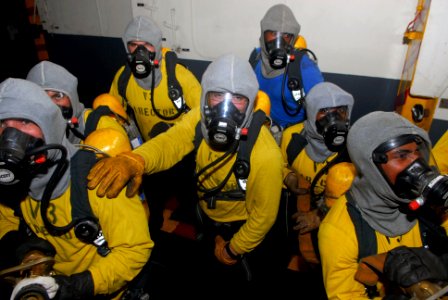US Navy 090501-N-0096C-098 Sailors from the air department of the aircraft carrier USS John C. Stennis (CVN 74) man a fire hose during a fire drill in the hangar bay