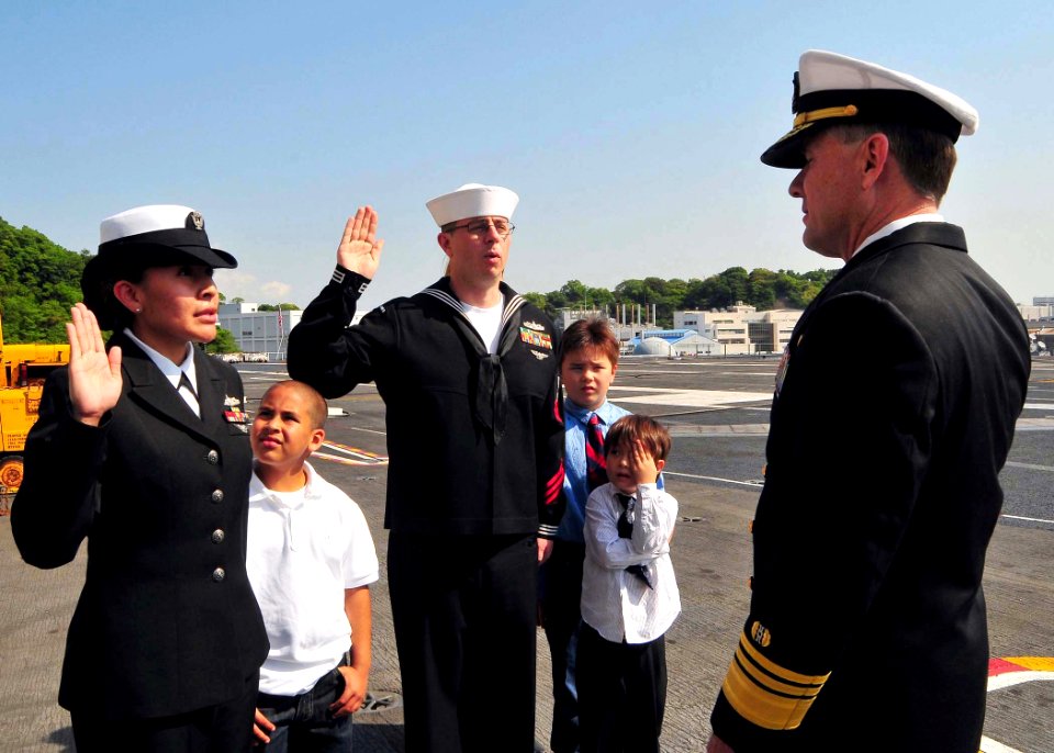 US Navy 090428-N-6233C-045 Vice Adm. Bruce MacDonald, Judge Advocate General of the U.S. Navy, re-enlists Legalman 1st Class Shawn Sargent and Legalman 2nd Class Marcella Grant