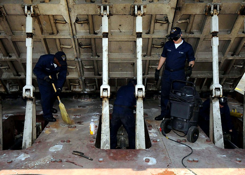 US Navy 090429-N-1062H-052 Sailors assigned to the air department of the aircraft carrier USS George Washington (CVN 73) clean the number four catapult jet blast deflector