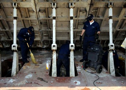 US Navy 090429-N-1062H-052 Sailors assigned to the air department of the aircraft carrier USS George Washington (CVN 73) clean the number four catapult jet blast deflector