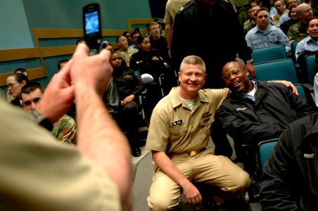 US Navy 090429-N-9818V-104 Master Chief Petty Officer of the Navy (MCPON) Rick West poses for a photo with a Sailor before an all-hands call at the Briefing Theater at Naval Station Everett