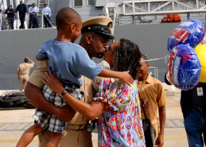 US Navy 090501-N-9134V-017 Chief Hospital Corpsman Tony Ward greets his family on the pier as the Arleigh Burke-class guided-missile destroyer USS Truxtun (DDG 103) arrives at its new homeport at Naval Station Norfolk