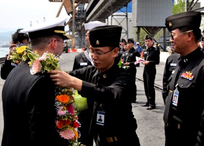 US Navy 090430-N-2638R-003 Cmdr. James T. Jones, commanding officer of the Arleigh Burke-class guided-missile destroyer USS Mustin (DDG 89), is welcomed by sailors in the Republic of Korea Navy photo