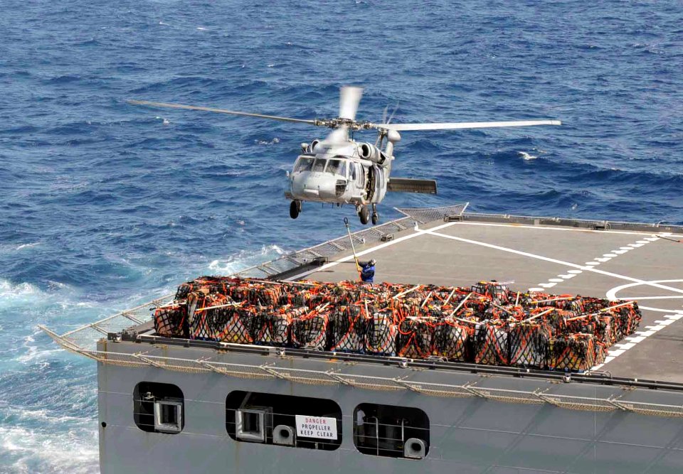 US Navy 090502-A-3007S-058 A helicopter from the Military Sealift Command hospital ship USNS Comfort (T-AH 20) picks up supplies