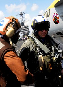 US Navy 090504-N-6538W-001 Commanding Officer, Cmdr. Jeffrey Czerewko of the Strike Fighter Squadron (VFA) 146 is greeted by his plane captain Aviation Electrician's Mate 3rd Class Adedamola Durojaiye, from Baltimore, on the fl