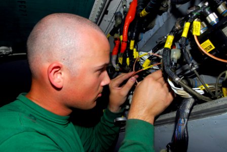 US Navy 090505-N-0096C-008 Aviation Electronics Technician 3rd Class Ryan Clogston, from Woodinville, Wash., replaces a pulse decoder on an FA-18C Hornet