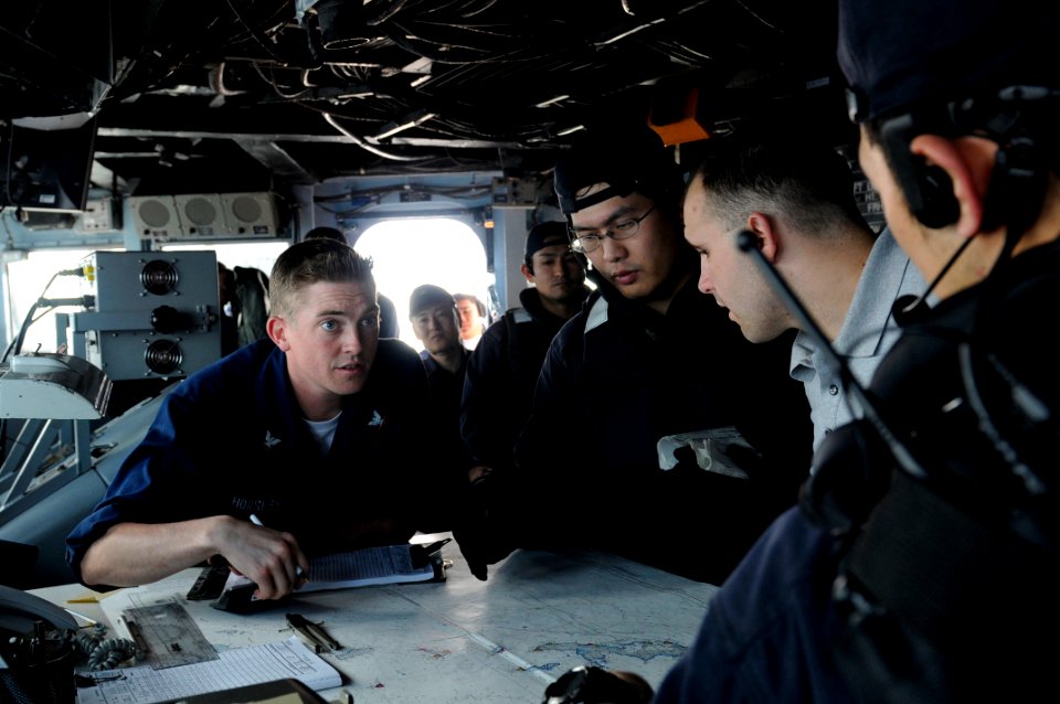 US Navy 090501-N-7280V-225 Quartermaster 3rd Class Philip Horsley explains the ships movement to members of the Japan Maritime Self-Defense Force aboard the amphibious command ship USS Blue Ridge (LCC 19) during an Exercise Mal