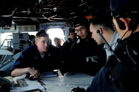 US Navy 090501-N-7280V-225 Quartermaster 3rd Class Philip Horsley explains the ships movement to members of the Japan Maritime Self-Defense Force aboard the amphibious command ship USS Blue Ridge (LCC 19) during an Exercise Mal