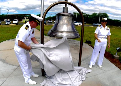 US Navy 090501-N-0995C-031 Lt. Cmdr. Jay Gulley, officer-in-charge of U.S. Naval Ammunition Depot, Oahu, Hawaii unveils a bell recovered from USS Hornet (CV 8) that was dedicated to the command for its 75th anniversary