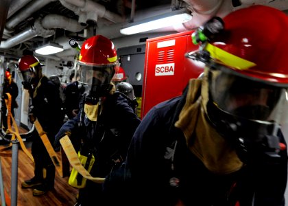 US Navy 090505-N-7280V-213 Sailors assigned to the flying squad aboard the amphibious command ship USS Blue Ridge (LCC 19) form a three-man attack team to combat a simulated fire