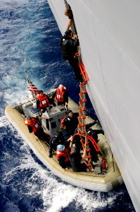 US Navy 090501-N-7478G-228 A member of the Japan Maritime Self-Defense Force boards the amphibious command ship USS Blue Ridge (LCC 19) while conducting a visit, board, search, and seizure drill during Exercise Malabar 2009