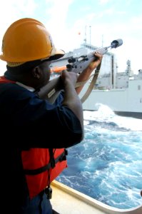 US Navy 090503-F-7522G-002 Boatswain Ricco Chandler, a civilian mariner onboard Military Sealift Command hospital ship USNS Comfort (T-AH 20), prepares to shoot a shot line