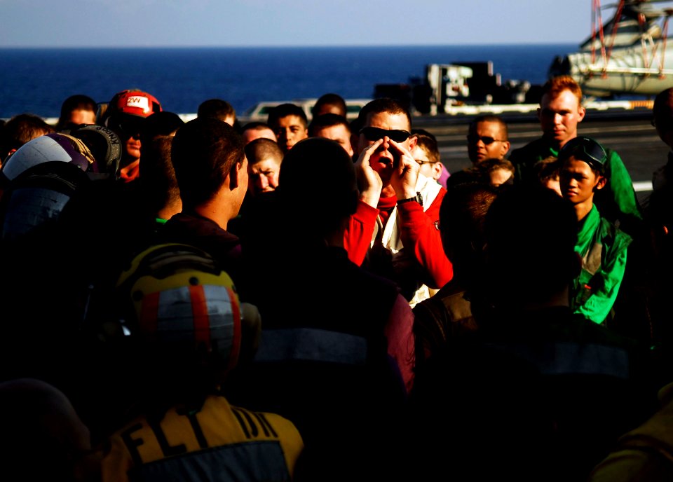 US Navy 090501-N-9928E-079 Lt. j.g. Keith King, center, from Sunset, Texas, congratulates flight deck personnel for a job well done following flight deck drills aboard the aircraft carrier USS John C. Stennis (CVN 74)