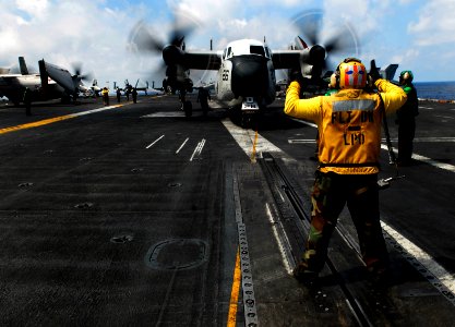 US Navy 090506-N-9928E-025 Aviation Boatswain's Mate (Handling) 1st Class James Webb, from Yokosuka, Japan, directs a C-2A Greyhound from the