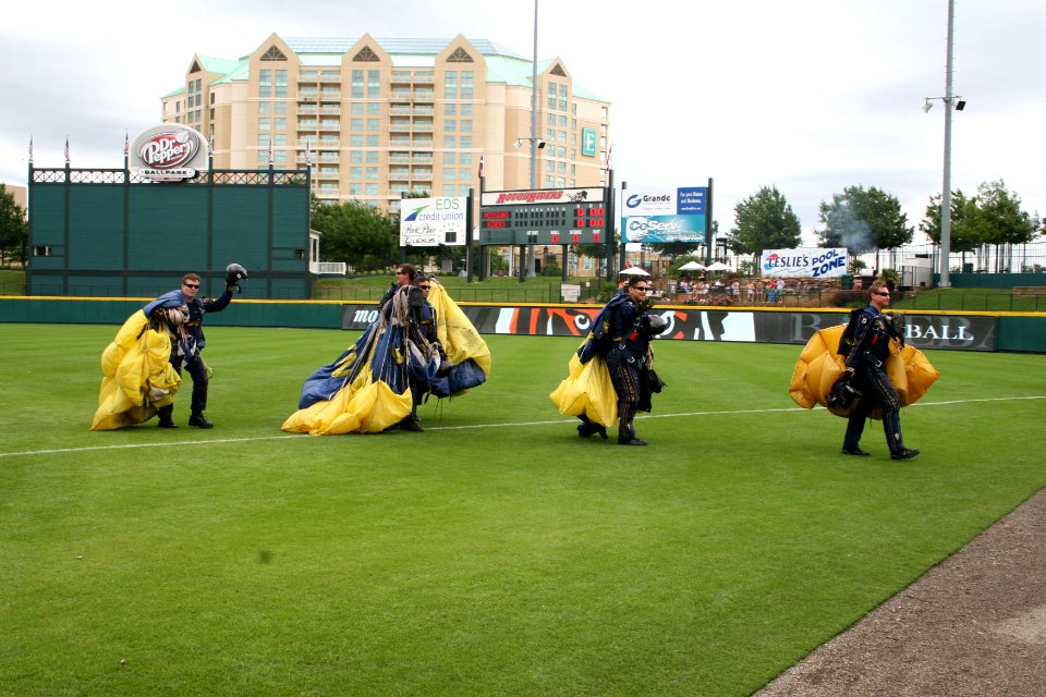 US Navy 090506-N-5366K-002 Members of the U.S. Navy Parachute Team the Leap Frogs wave to a cheering crowd after parachuting into Dr. Pepper Ball Park