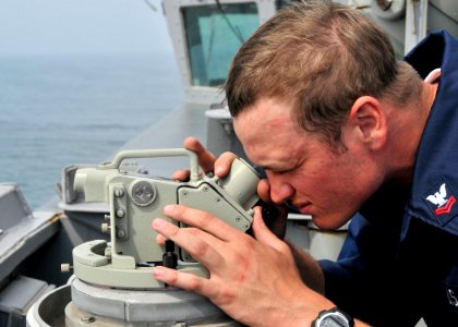 US Navy 090505-N-2638R-002 Boatswain's Mate 2nd Class Jeff Stillman, from Pocahontas, Ill, uses an alidade telescope to look for surface contacts from the bridge wing of guided-missile destroyer USS Mustin (DDG 89)