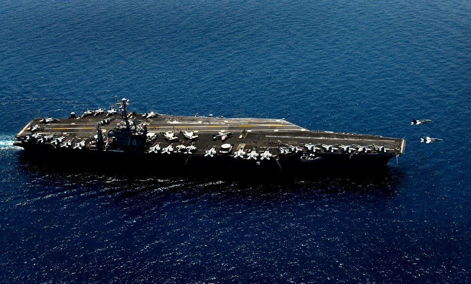 US Navy 090504-N-9928E-127 Two F-A-18C Hornets from the Blue Diamonds of Strike Fighter Squadron (VFA) 146 launch from the flight deck of the Nimitz-class aircraft carrier USS John C. Stennis (CVN 74) during an airborne change