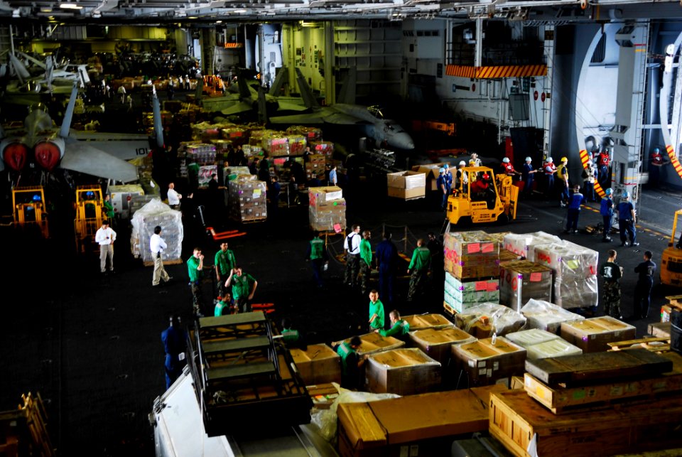 US Navy 090507-N-2475A-028 Sailors from supply and deck department move pallets throughout the hangar bays aboard the aircraft carrier USS John C. Stennis (CVN 74)