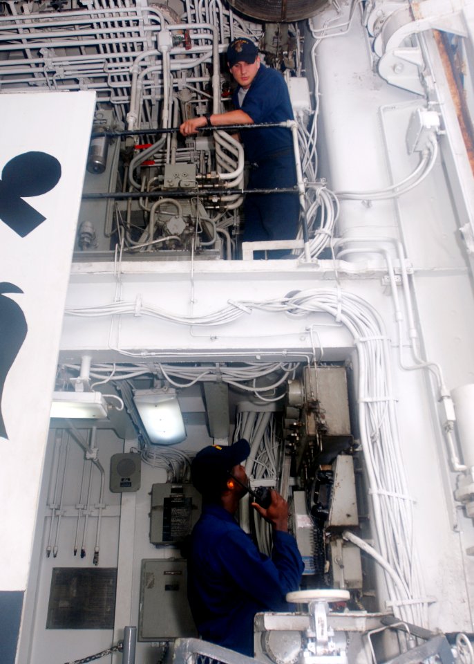 US Navy 090510-N-5215E-045 Machinist Mate 3rd Class KanGoma Tulay and Machinist's Mate Fireman Nicholas Healy perform maintenance