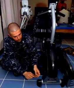 US Navy 090506-F-7923S-015 Hospital Corpsman 1st Class Anthony Foht, a biological medical repair technician embarked aboard the Military Sealift Command hospital ship USNS Comfort (T-AH 20), replaces computer chips on a physica