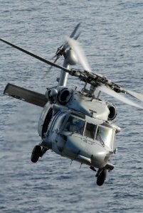 US Navy 090507-N-9909C-415 GULF OF OMAN (May 7, 2009) An MH-60S Sea Hawk helicopter from Helicopter Sea Combat Squadron (HSC) 28 hovers over the flight deck of the guided-missile cruiser USS Vicksburg (CG 69)