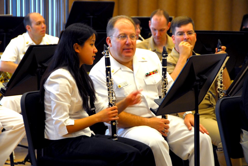 US Navy 090506-N-0773H-023 Clarinet instrumentalist Rebekah Carpio, the winner of the 9th Annual Navy Band Concerto Competition, discusses changes in the music with fellow clarinet instrumentalist, Chief Musician Russell V. Gro