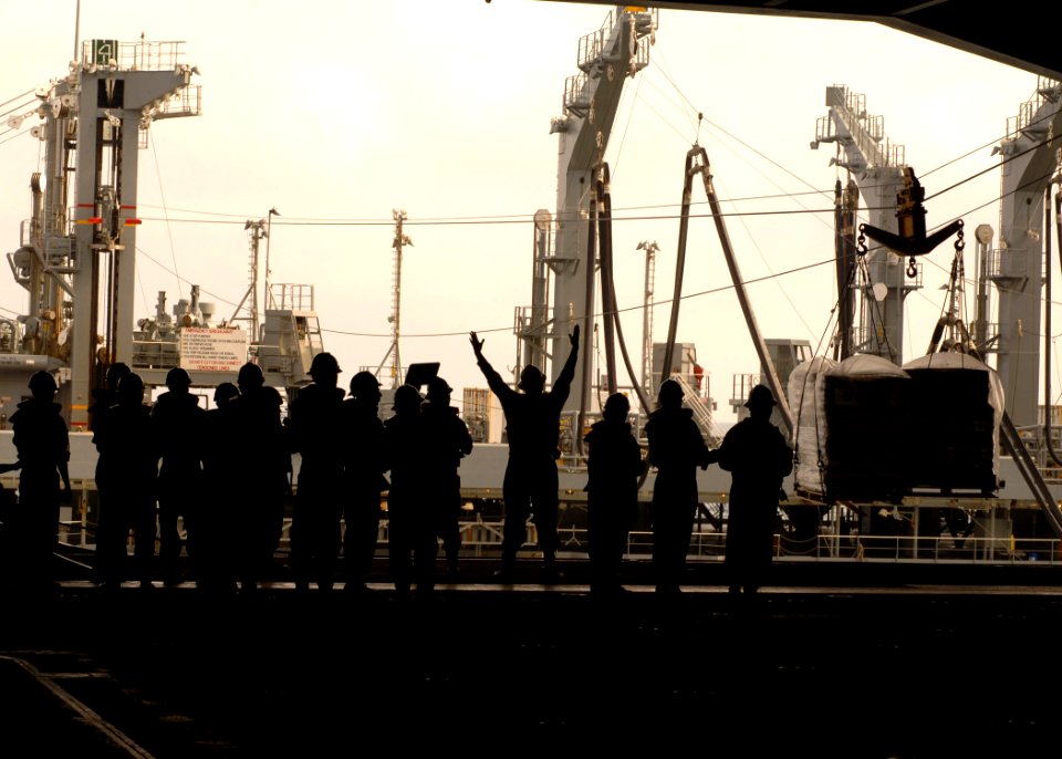 US Navy 090508-N-7282P-038 Sailors aboard the aircraft carrier USS George Washington (CVN 73) signal to the Military Sealift Command fleet replenishment oiler USNS John Ericsson (T-AO 194) from the hanger bay during a replenish