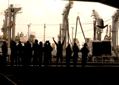 US Navy 090508-N-7282P-038 Sailors aboard the aircraft carrier USS George Washington (CVN 73) signal to the Military Sealift Command fleet replenishment oiler USNS John Ericsson (T-AO 194) from the hanger bay during a replenish