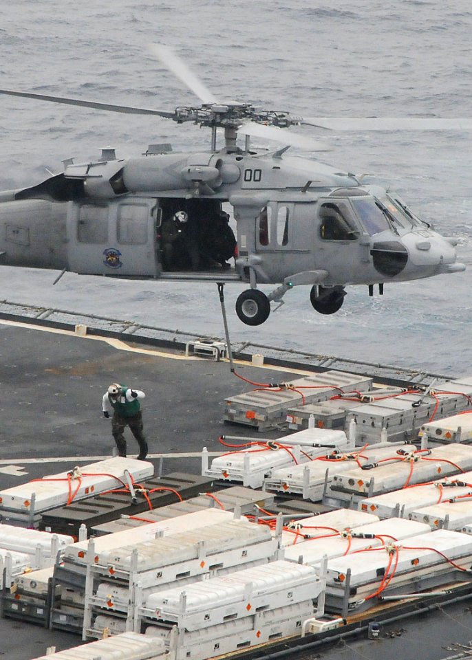 US Navy 090511-N-1644H-052 PACIFIC OCEAN (May 11, 2009) A crew member of the Military Sealift Command dry cargo-ammunition ship USNS Alan Shepard (T-AKE 3) moves clear after slinging a load