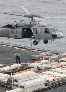 US Navy 090511-N-1644H-052 PACIFIC OCEAN (May 11, 2009) A crew member of the Military Sealift Command dry cargo-ammunition ship USNS Alan Shepard (T-AKE 3) moves clear after slinging a load