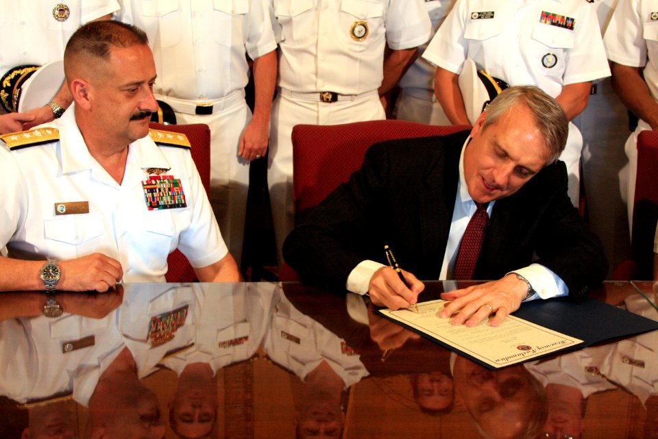 US Navy 090507-N-3038C-528 Rear Adm. Albert Garcia III, deputy commander, Naval Facilities Engineering Command deputy chief of civil engineers, watches as Colorado Governor Bill Ritter signs the 2009 Denver Navy Week proclamati