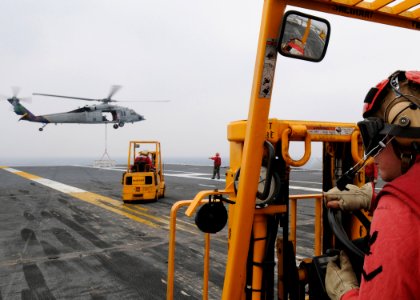 US Navy 090511-N-1062H-080 PACIFIC OCEAN (May 11, 2009) Aviation Ordinanceman 3rd Class Jared Glidden operates a forklift aboard the aircraft carrier USS George Washington (CVN 73) during a weapons transfer with the Military Se