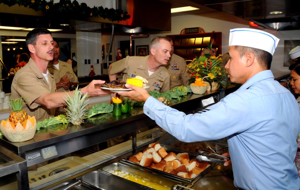 US Navy 090511-N-3666S-002 PEARL HARBOR (May 11, 2009) A Sailor assigned to Naval Station Pearl Harbor serves lunch to Vice Adm. Michael Vitale, commander, Naval Installations Command