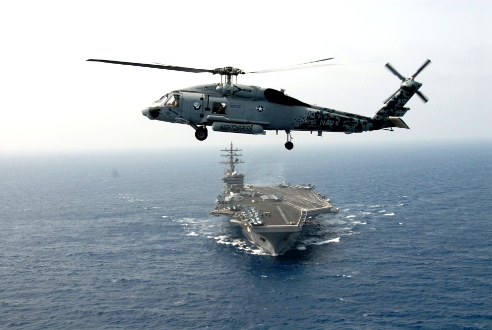 US Navy 090509-N-9909C-664 GULF OF OMAN (May 9, 2009) An SH-60F Sea Hawk helicopter assigned to Helicopter Antisubmarine Squadron (HS) 5 hovers over the bow of the aircraft carrier USS Dwight D. Eisenhower (CVN 69)