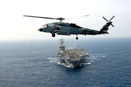 US Navy 090509-N-9909C-664 GULF OF OMAN (May 9, 2009) An SH-60F Sea Hawk helicopter assigned to Helicopter Antisubmarine Squadron (HS) 5 hovers over the bow of the aircraft carrier USS Dwight D. Eisenhower (CVN 69)