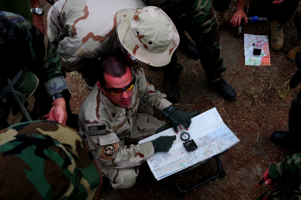 US Navy 090512-N-7200S-019 Mass Communication Specialist 1st Class Brandon Raile, assigned to Fleet Combat Camera Group Pacific, shows Students how to align maps to magnetic north